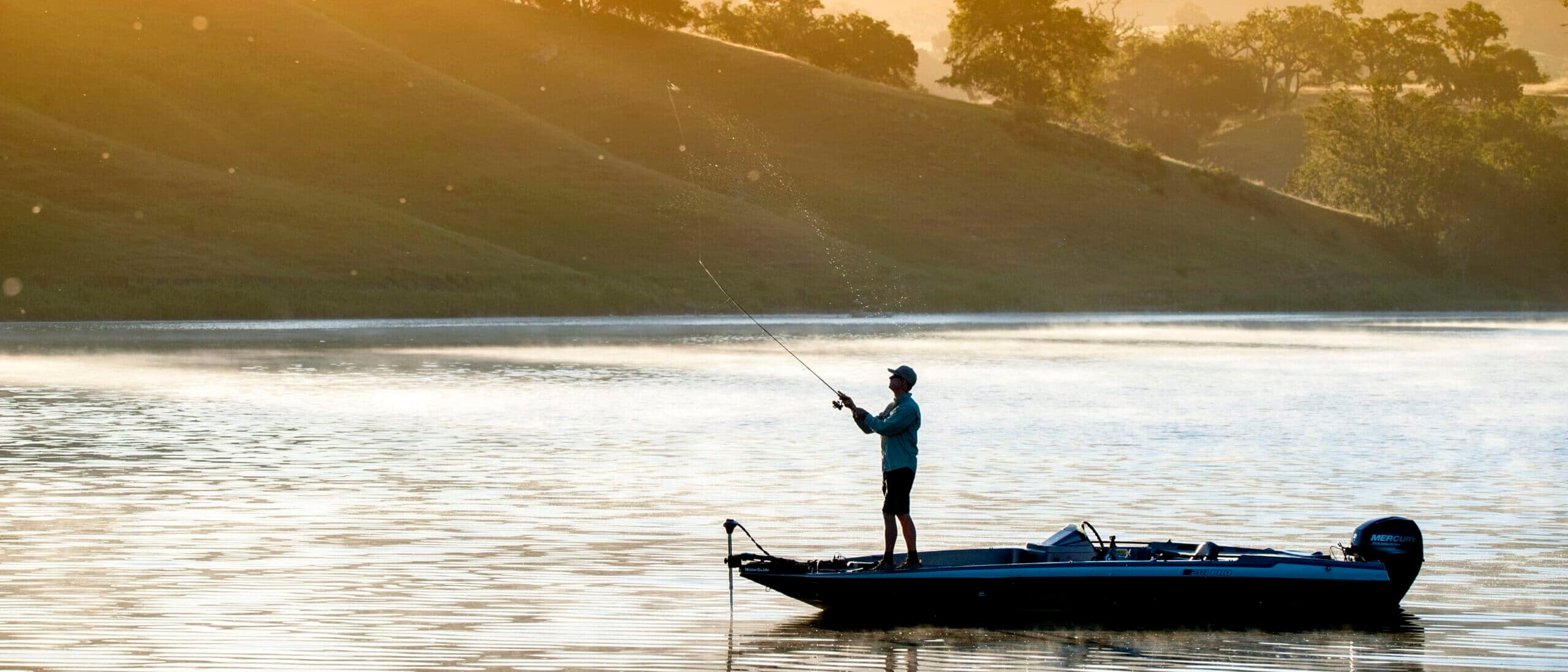 Man enjoying fly fishing on the lake at Alisal Ranch during sunset